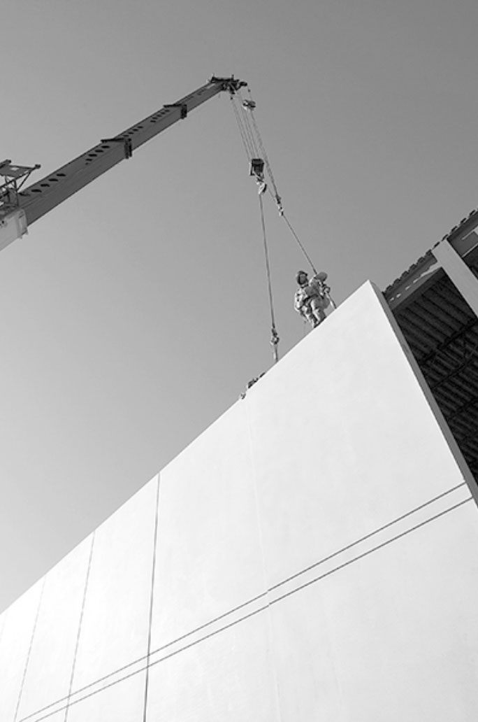 working with crane working on building construction